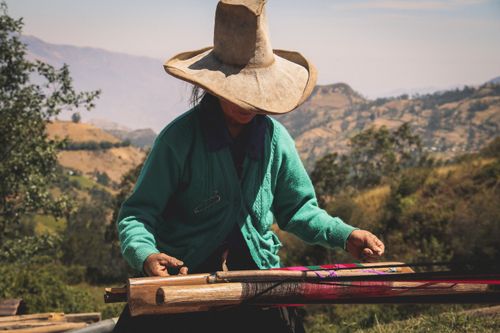 Free A woman weaves with traditional techniques in the scenic mountains of Cajamarca, Peru. Stock Photo