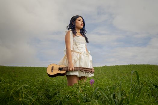 Woman with Guitar Standing on Field
