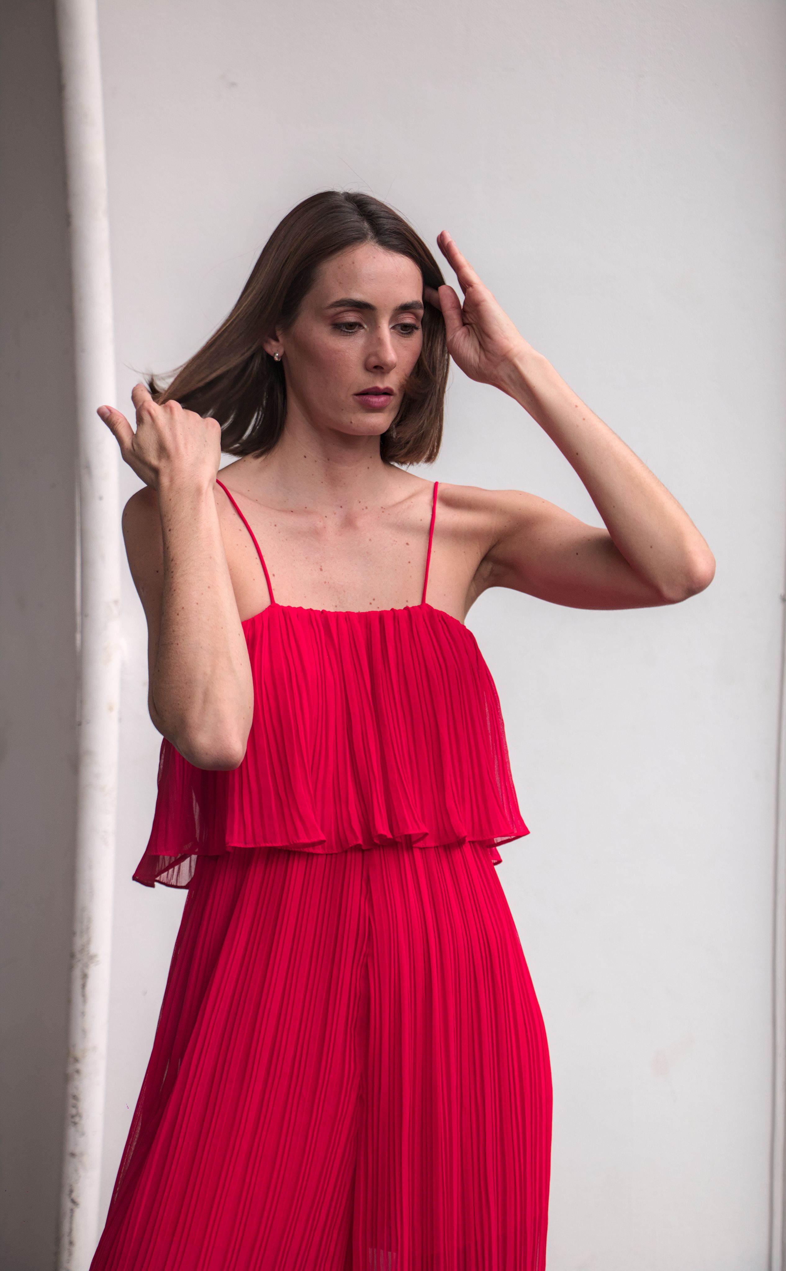 Young Woman in a Red Dress Posing in Studio · Free Stock Photo