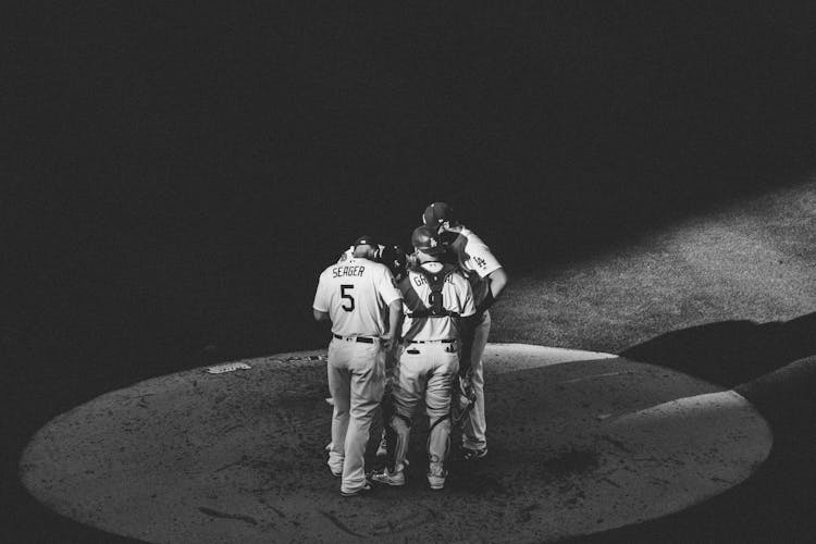 High Angle Shot Of A Group Of Baseball Players Talking 