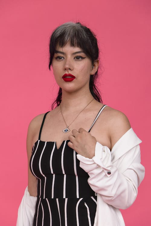 Young Woman Wearing Fashionable Clothing and Red Lipstick Posing in Studio 