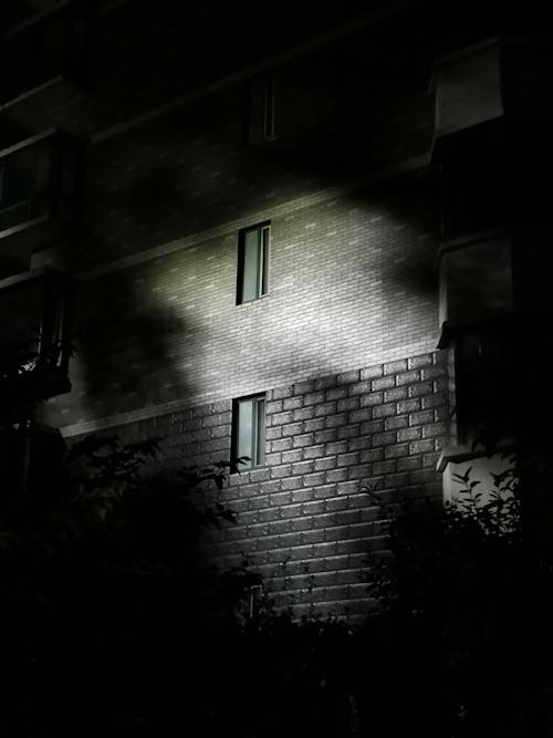 Black and White Picture of a Residential Building in City at Night 