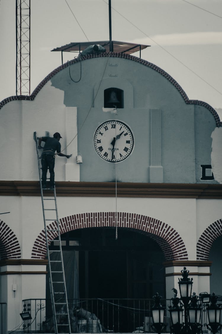 Man Painting Building Wall