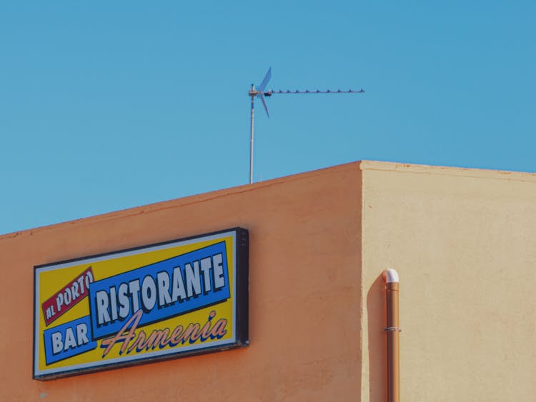 Close-up Of Board With A Restaurant Name 