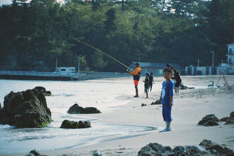 Boy Standing On Beach