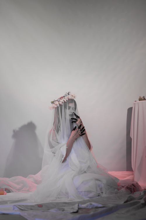 Woman in a Bride Halloween Costume Sitting on the Floor 