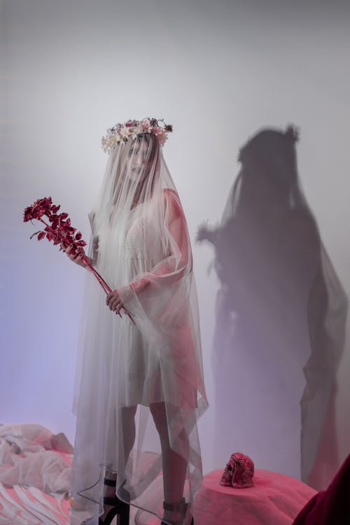 Woman in a Bride Halloween Costume Holding Flowers