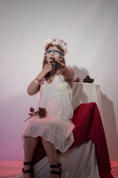 Woman in a Halloween Costume Sitting on a Chair Blindfolded