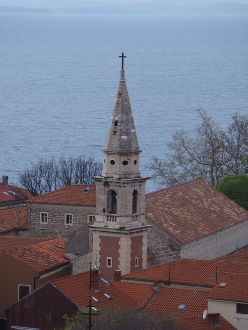 Free Scenic view of a historic town with a prominent church steeple near the coast. Stock Photo