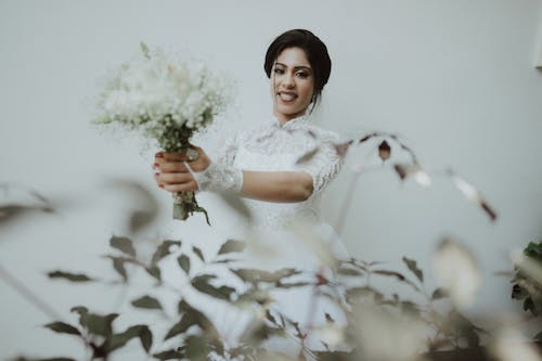 Bride Standing with a Bouquet of Flowers in her Hands