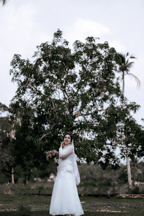 Bride in a Wedding Dress Posing Outdoors 