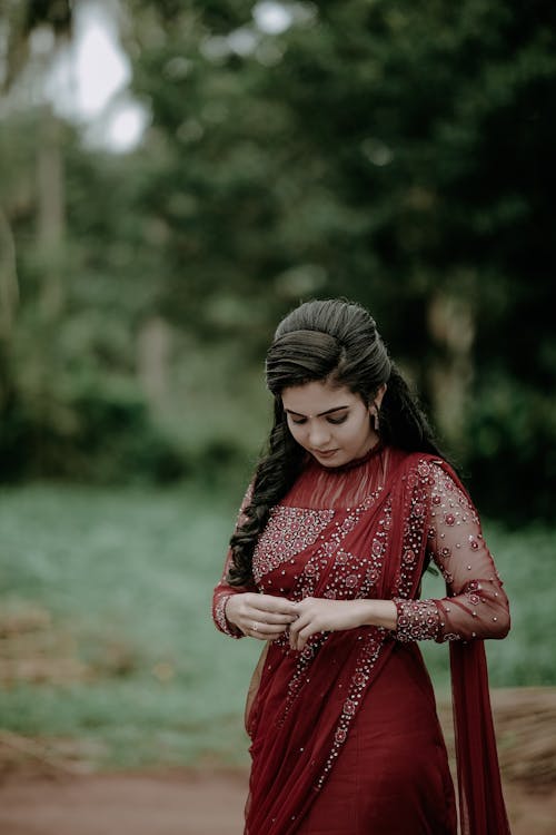 Woman in Traditional Dress Posing and Looking Down