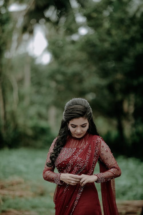 Woman Standing and Posing in Red Dress