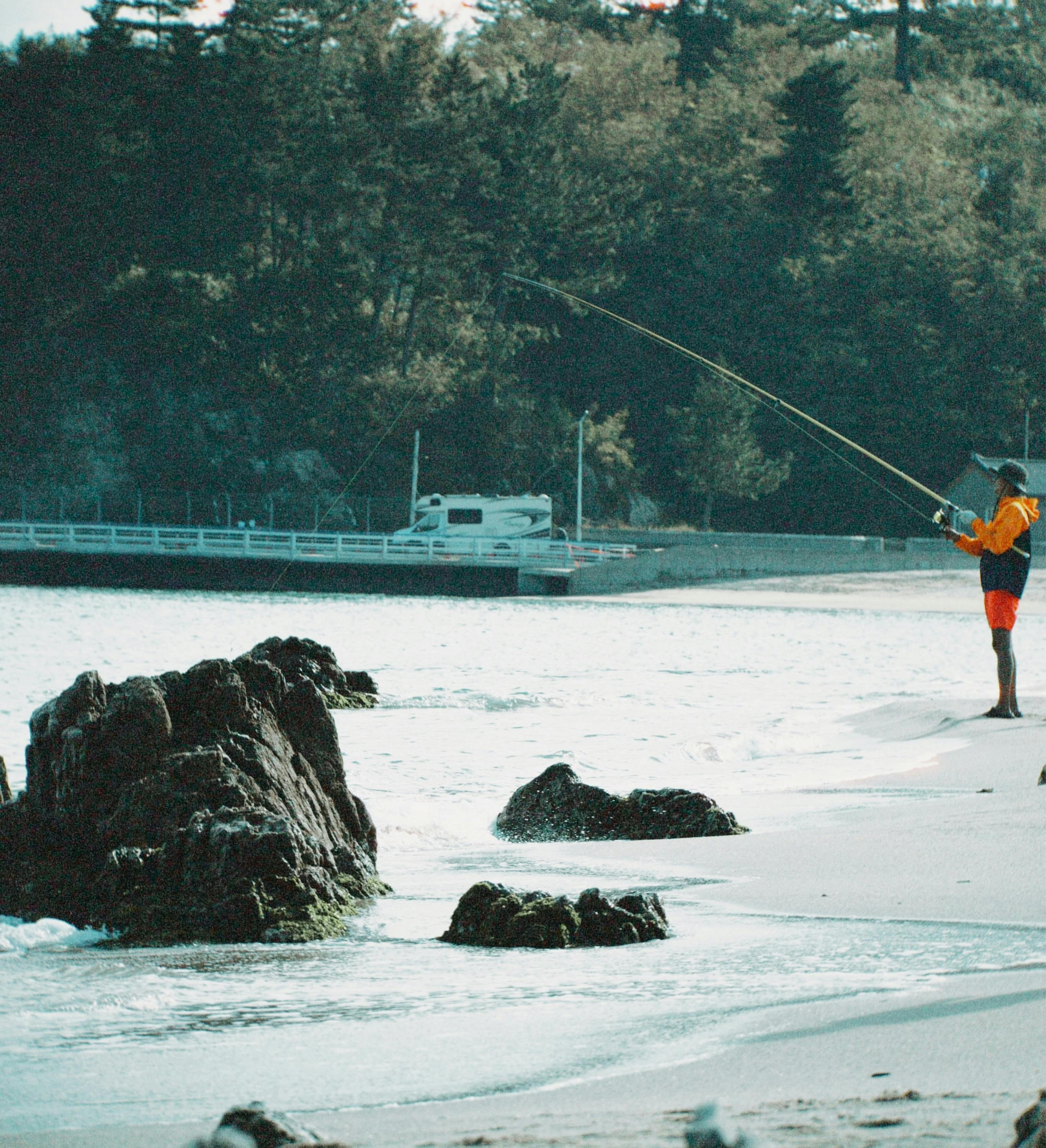 fisherman fishing on beach