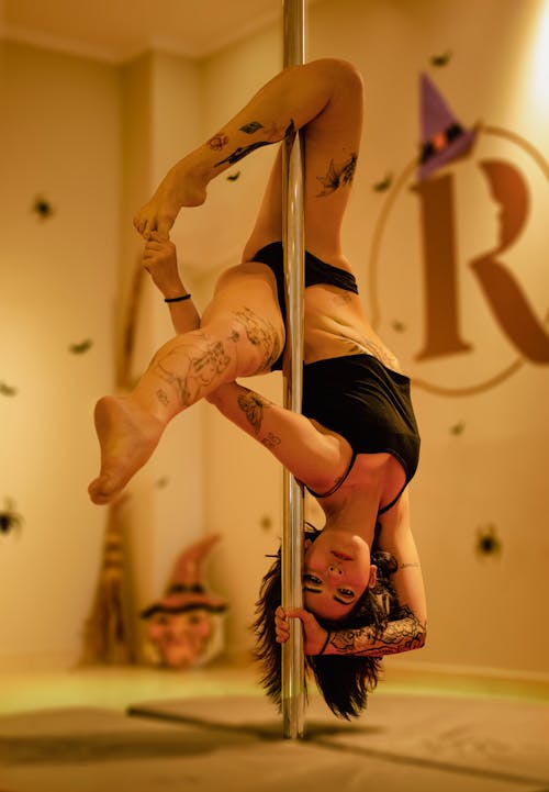 Woman with Tattoos Dancing on a Pole 