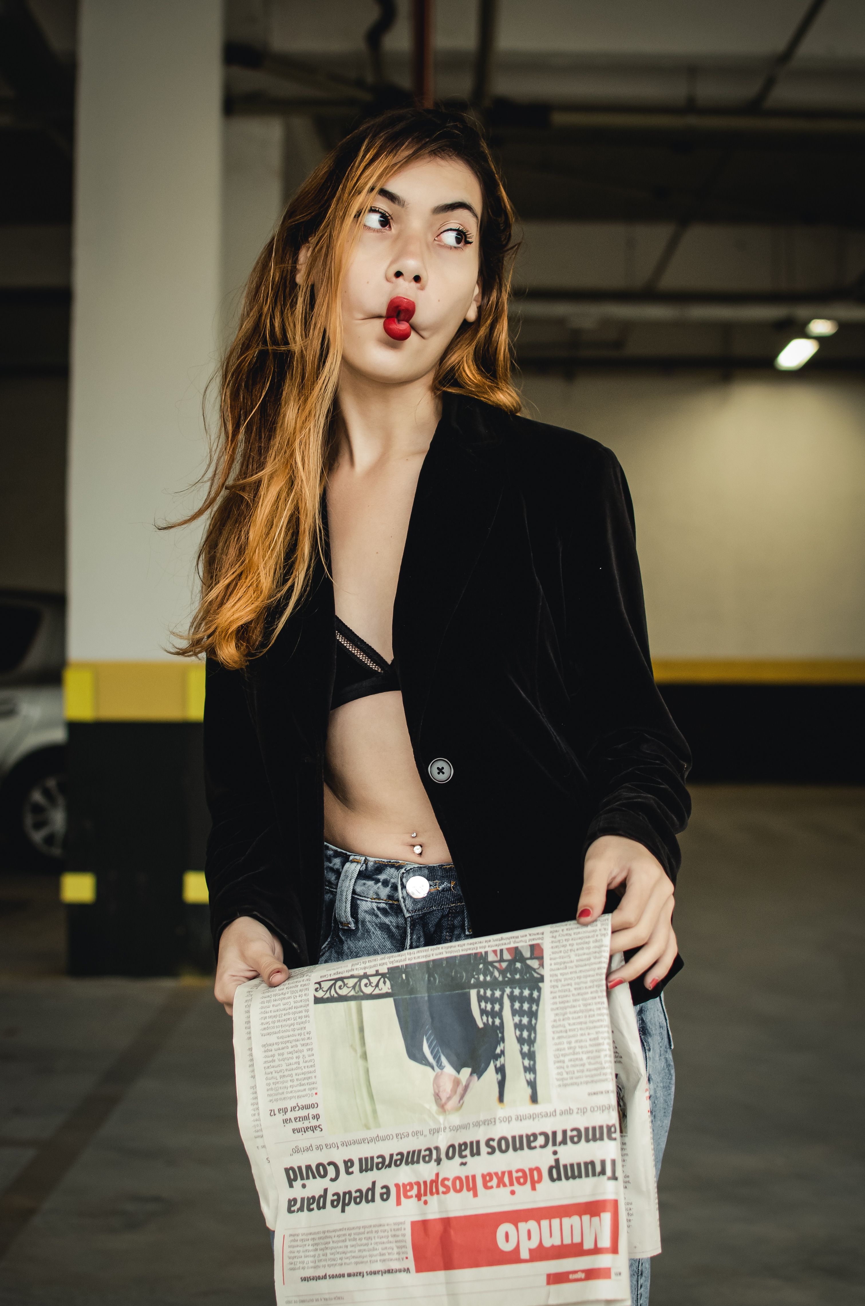 Woman with Newspaper at Parking Lot · Free Stock Photo