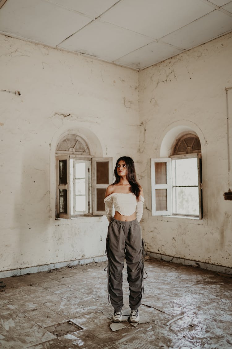 Young Brunette Standing In An Abandoned House 