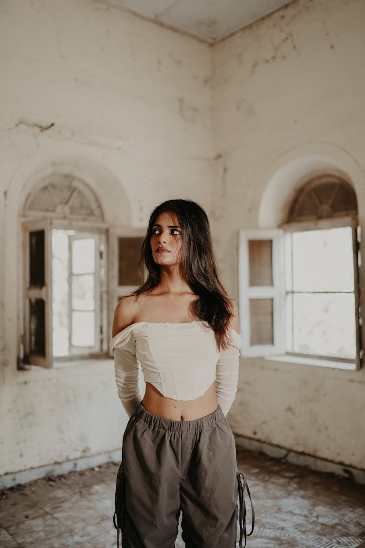 Young Brunette Standing In An Abandoned House 