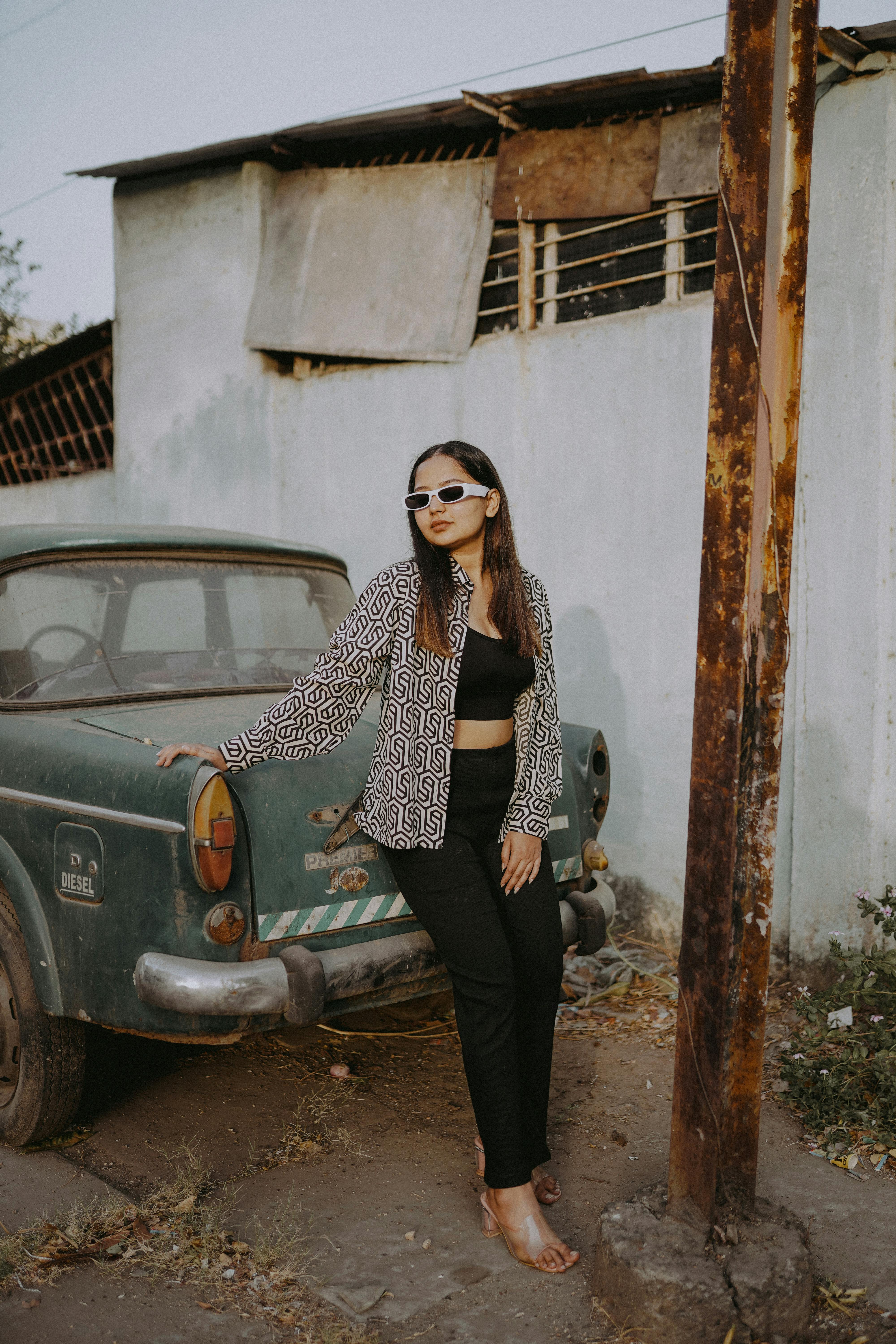Premium Photo | Beautiful fashionable young woman in glasses posing near car