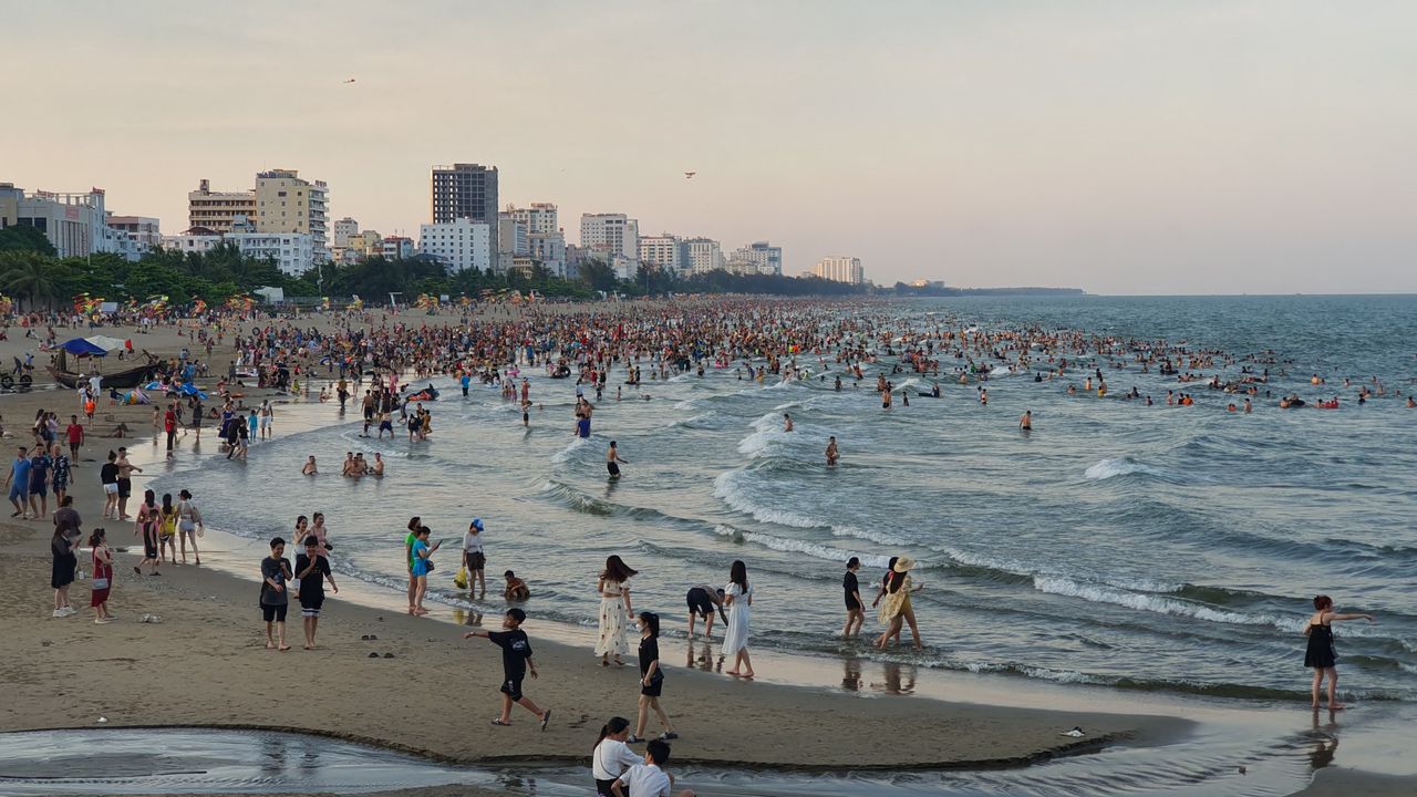 crowded s m s n beach in vietnam with people enjoying the summer by th