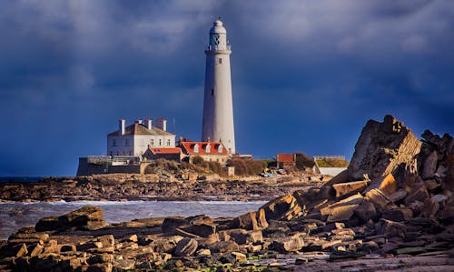 White Lighthouse Near Body of Water