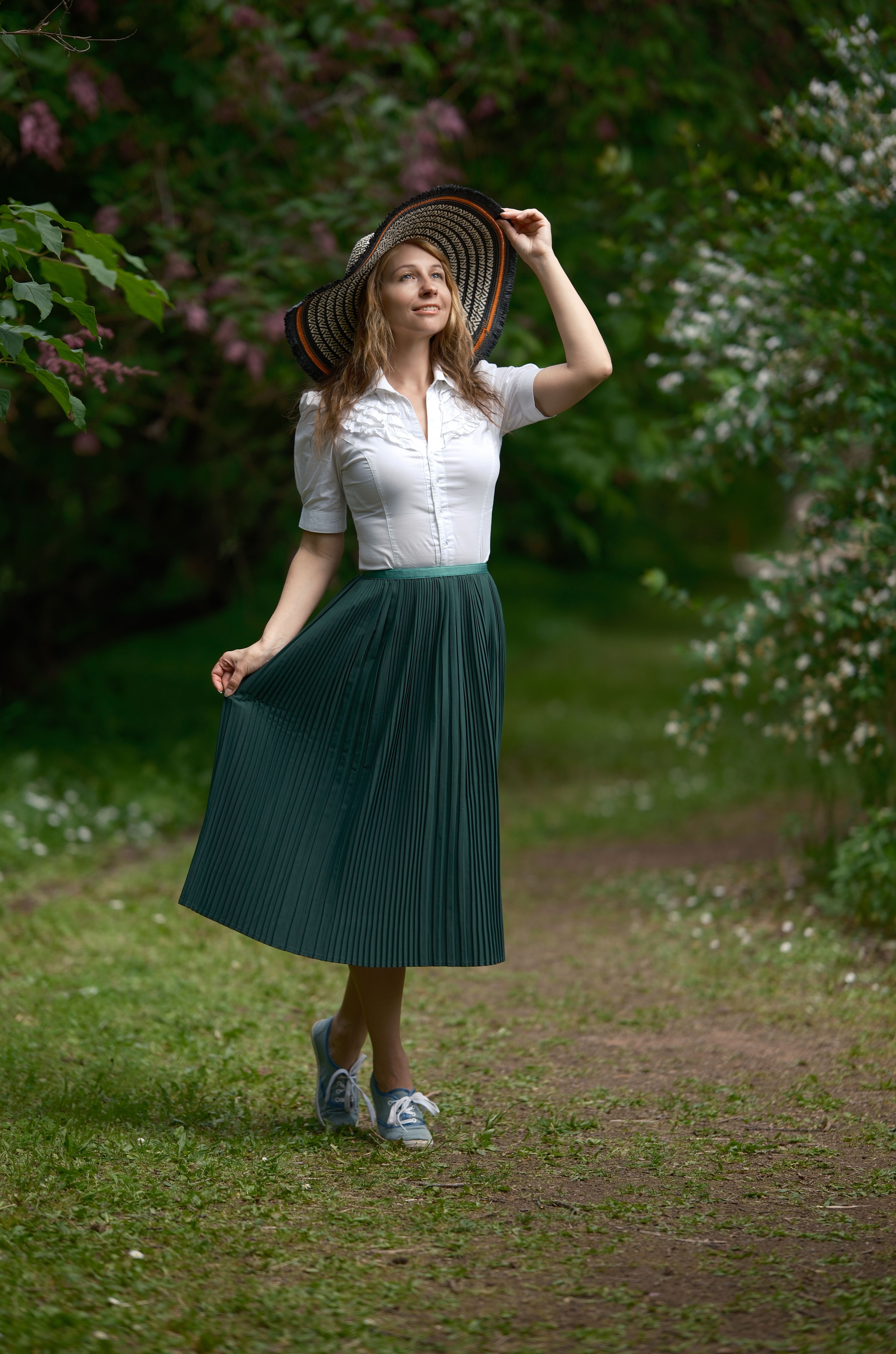 Woman wearing a forest green cardigan set with a midi skirt