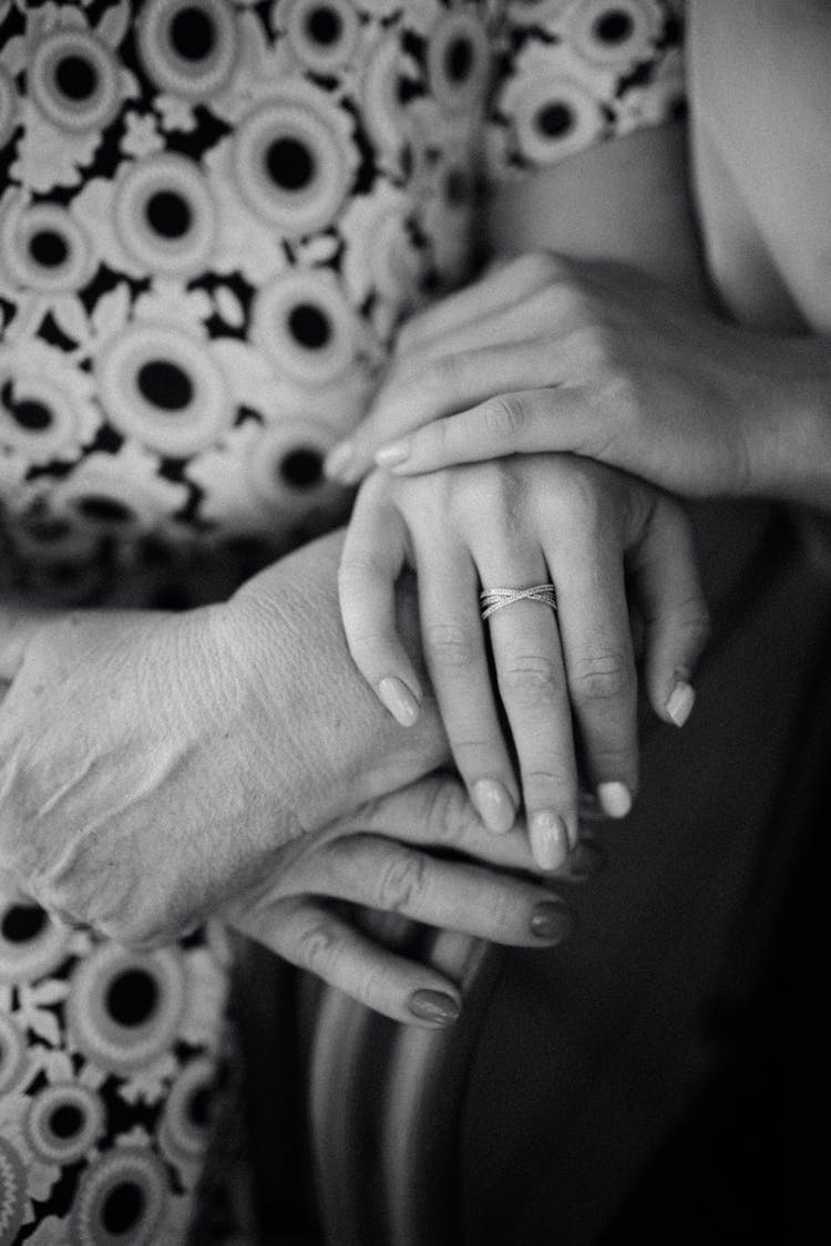 Mother And Daughter Holding Hands Together