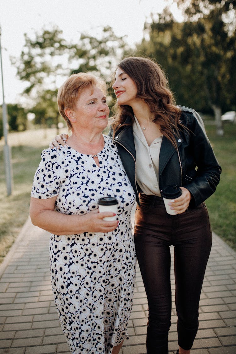 Happy Mother And Daughter Walking In The Park