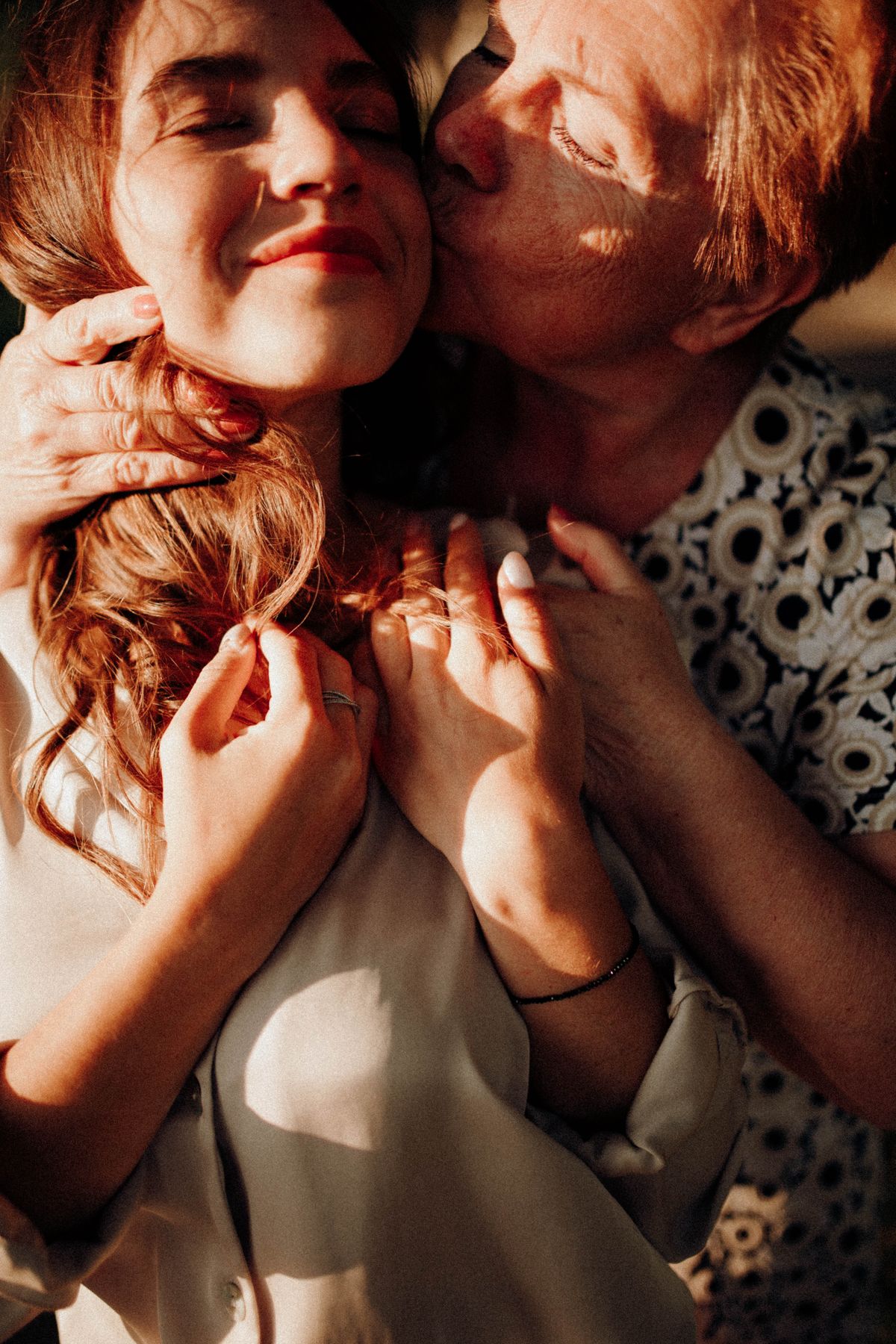 Mãe idosa e filha adulta em gesto de carinho
