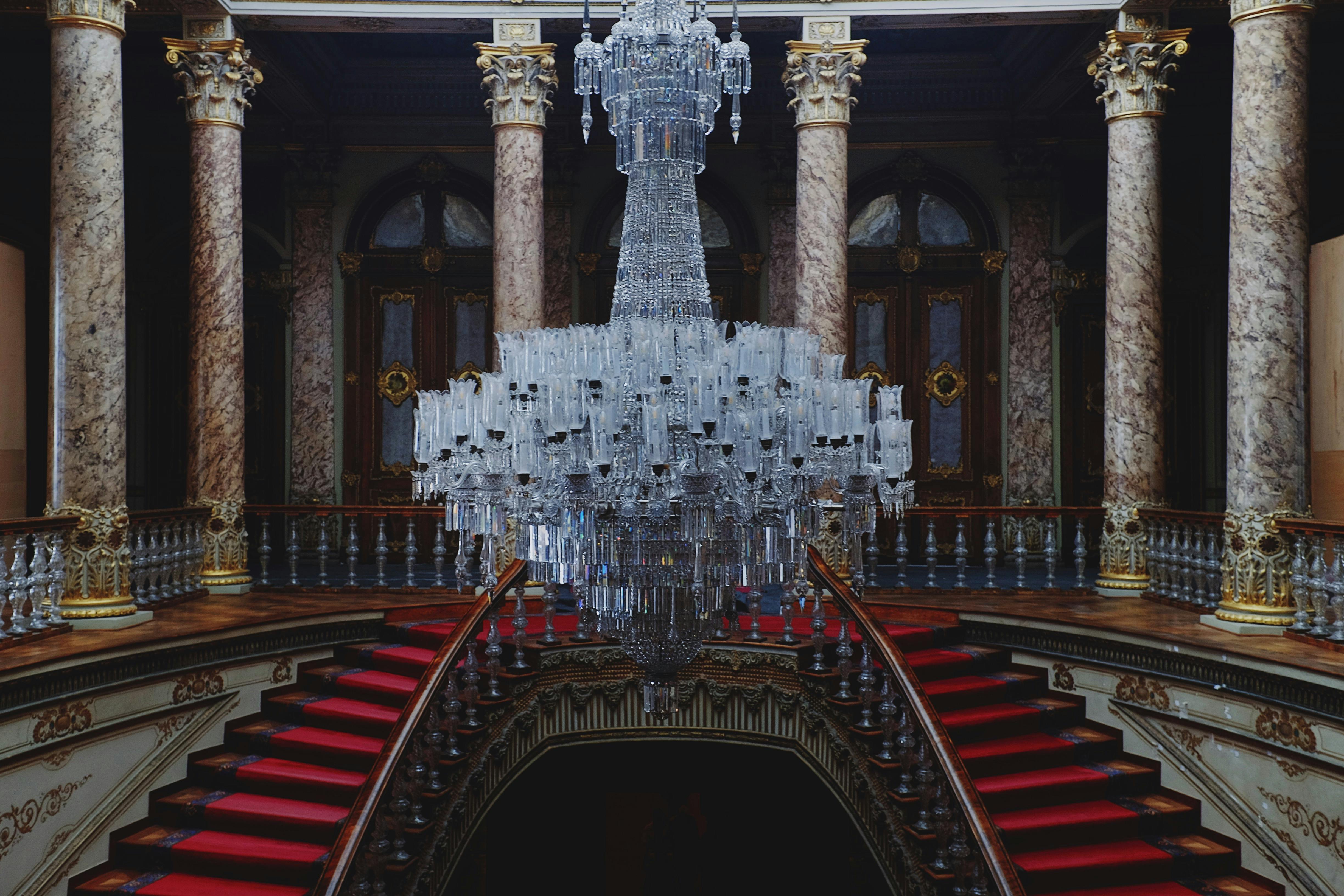 Elegant grand staircase with ornate chandelier inside a historic building in Istanbul, Turkey.