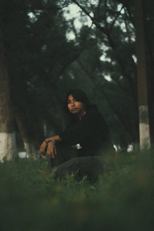 Man in Black Pullover Squatting and Posing