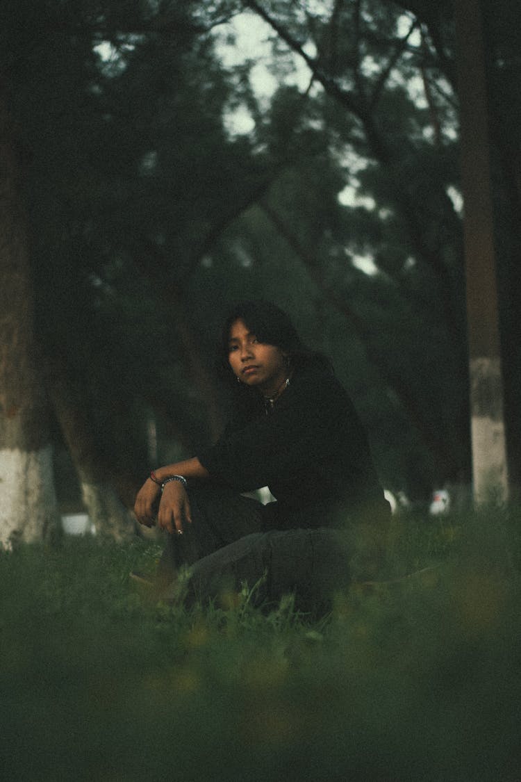 Man In Black Pullover Squatting And Posing