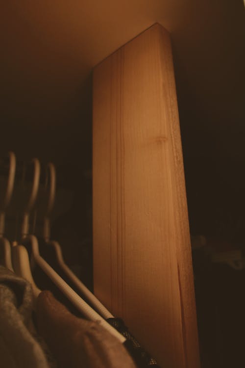 Close-up of Clothes on Hangers in a Wardrobe 