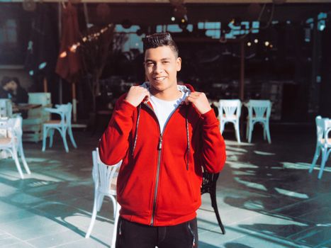 Man Holding His Red Hoodie