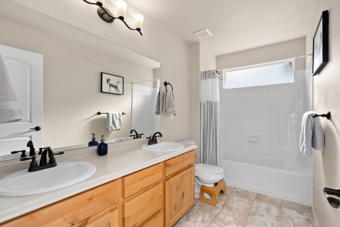 Bright, clean modern bathroom with dual sinks and natural light