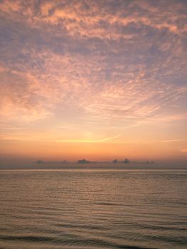 Mesmerizing ocean view at sunset with a vibrant sky reflecting on calm waters, perfect for relaxation.
