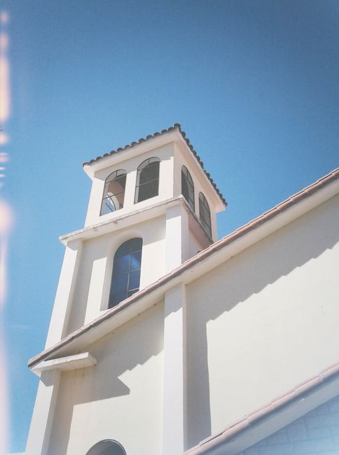 A bright, tall church tower showcasing colonial architecture in Mendoza.