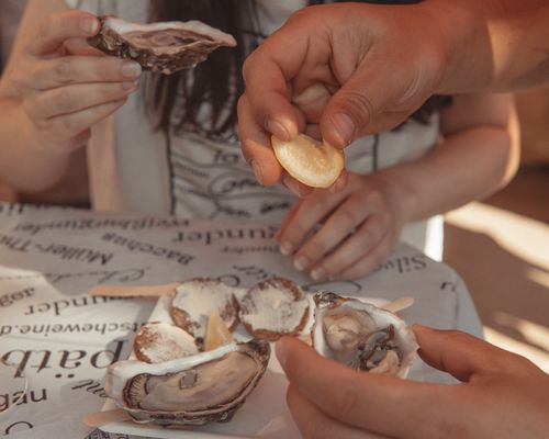 Free Close-up of fresh oysters with lemon being served in a cozy indoor setting. Stock Photo