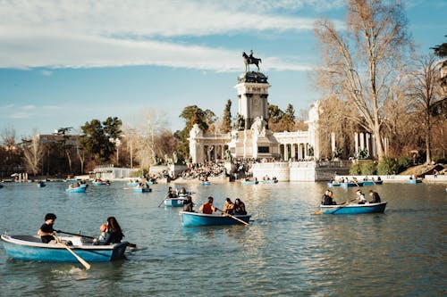 People on Blue Boats on Great Pond of Retiro Park in Madrid, Spain