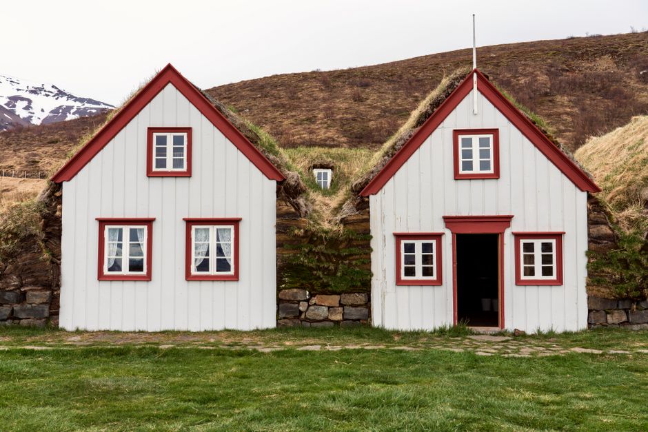 Scenic view of historic turf houses nestled in Iceland's natural landscape.
