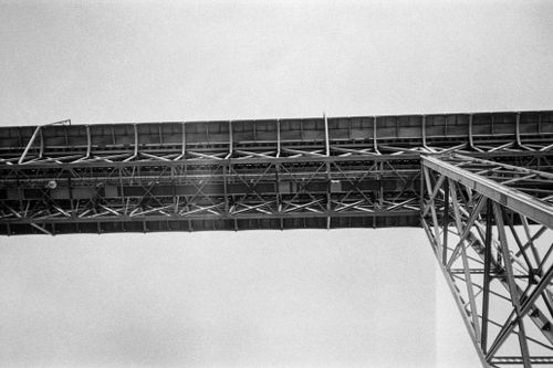 Free Black and white film photo of a steel bridge capturing architectural symmetry in Porto, Portugal. Stock Photo
