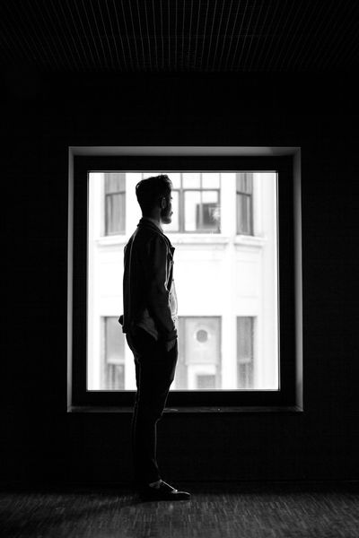 Silhouette of a Person Standing near the Windows · Free Stock Photo