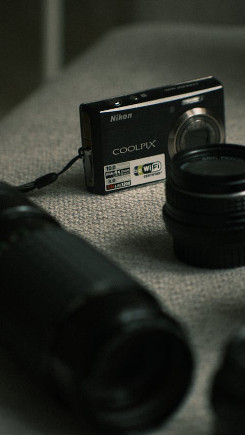 Digital Camera Lying Next to a Lens