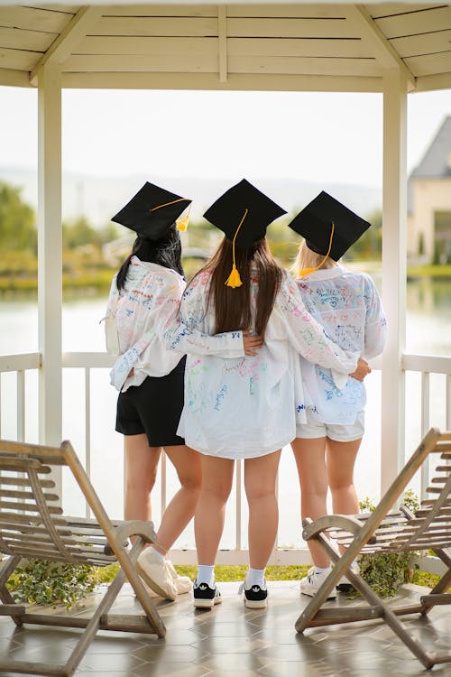 Three Girls Wearing Mortarboards