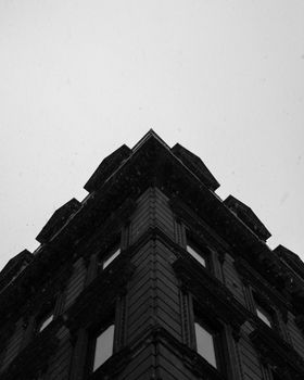 Dramatic low-angle view of a building corner in Montreal's urban landscape.