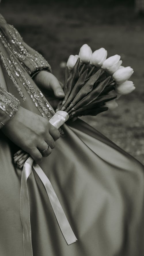 Close-up of Woman in an Elegant Dress Holding a Bouquet