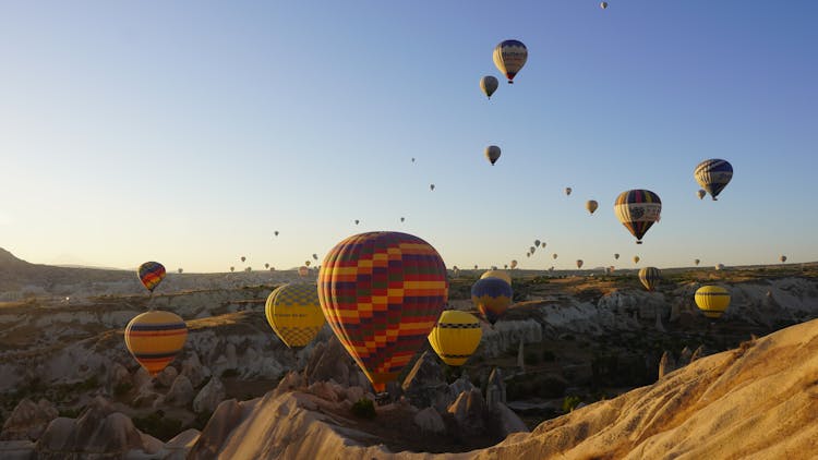 Hot Air Balloons Flying Over Cappadocia Landscape