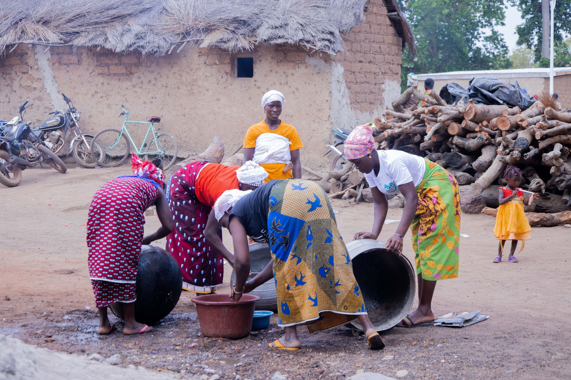 African women engaged in community work in a rural village setting in Korhogo, Côte d'Ivoire.
