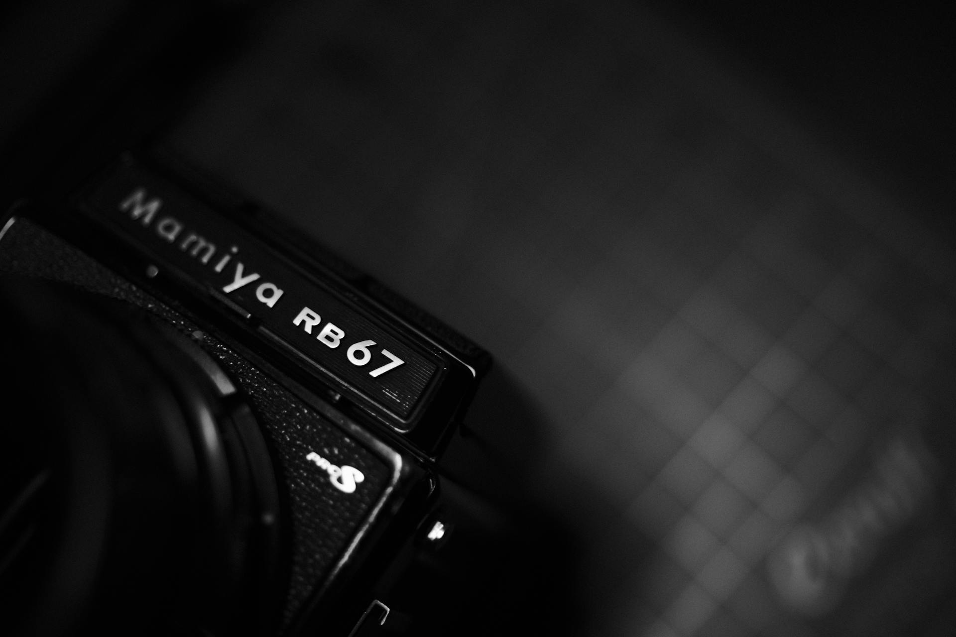 Black and white close-up of a Mamiya RB67 film camera, showcasing its iconic design.