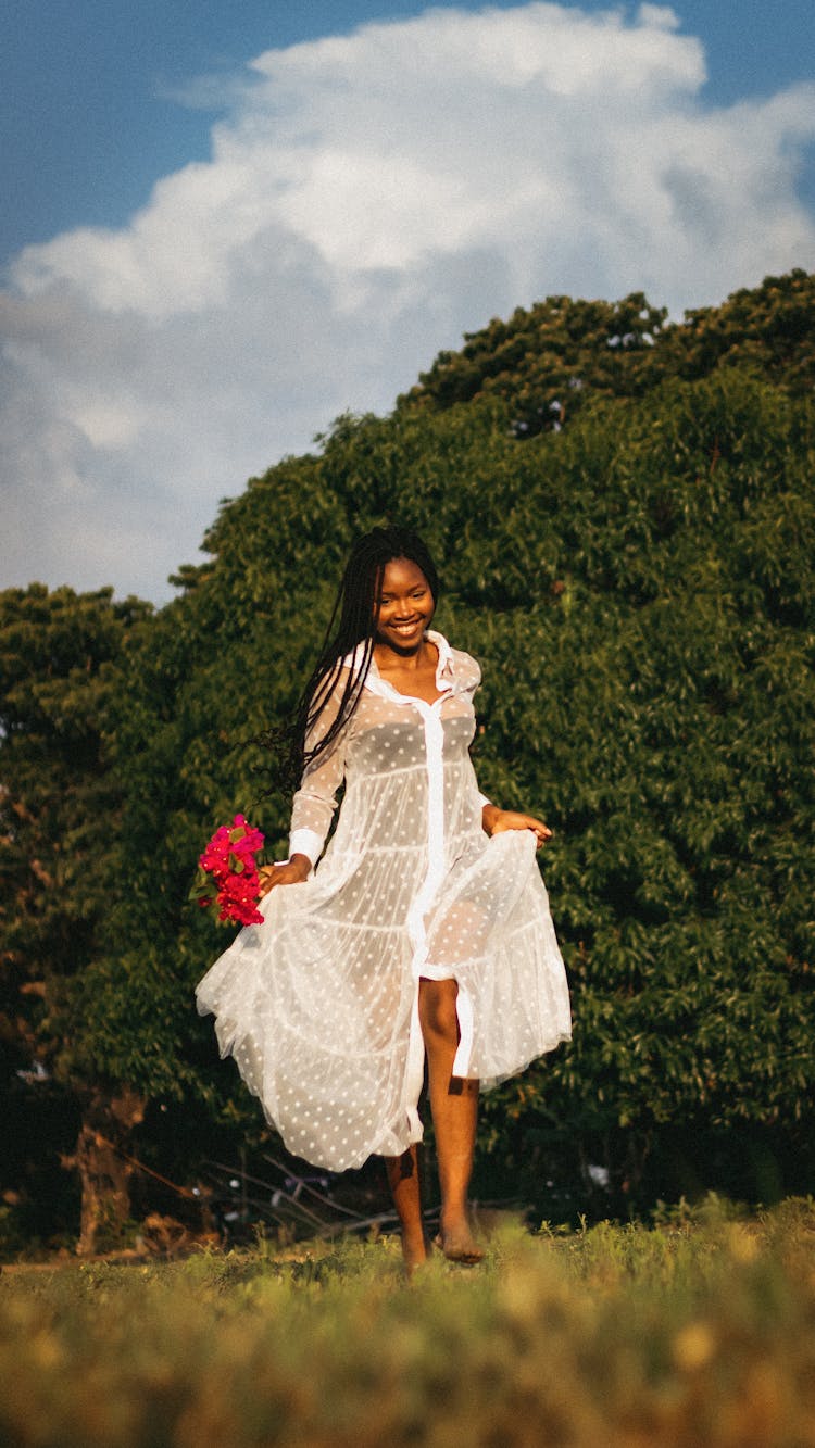 Woman In Dress Running On Grass